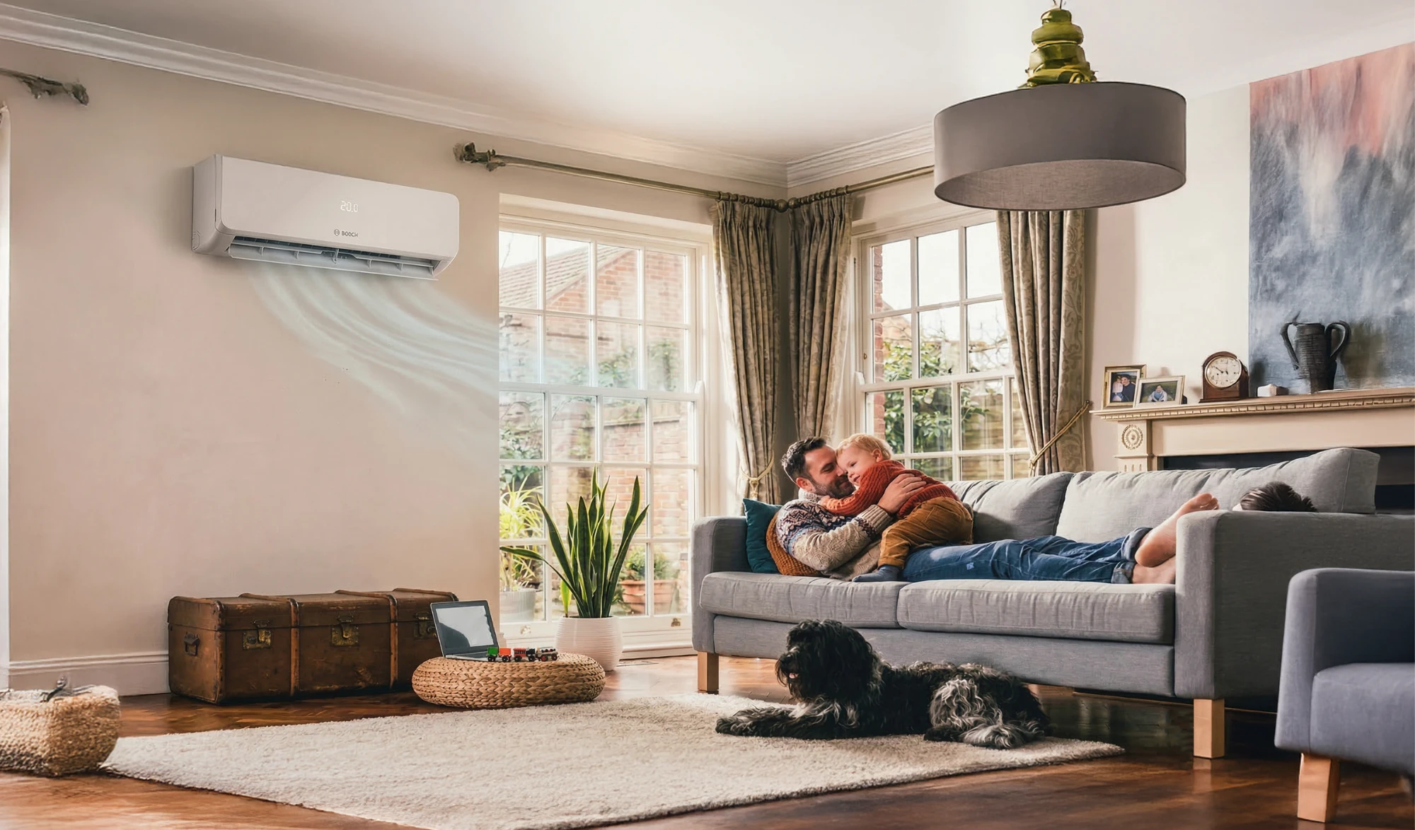 A family relaxing in a living room cooled by a Bosch wall unit