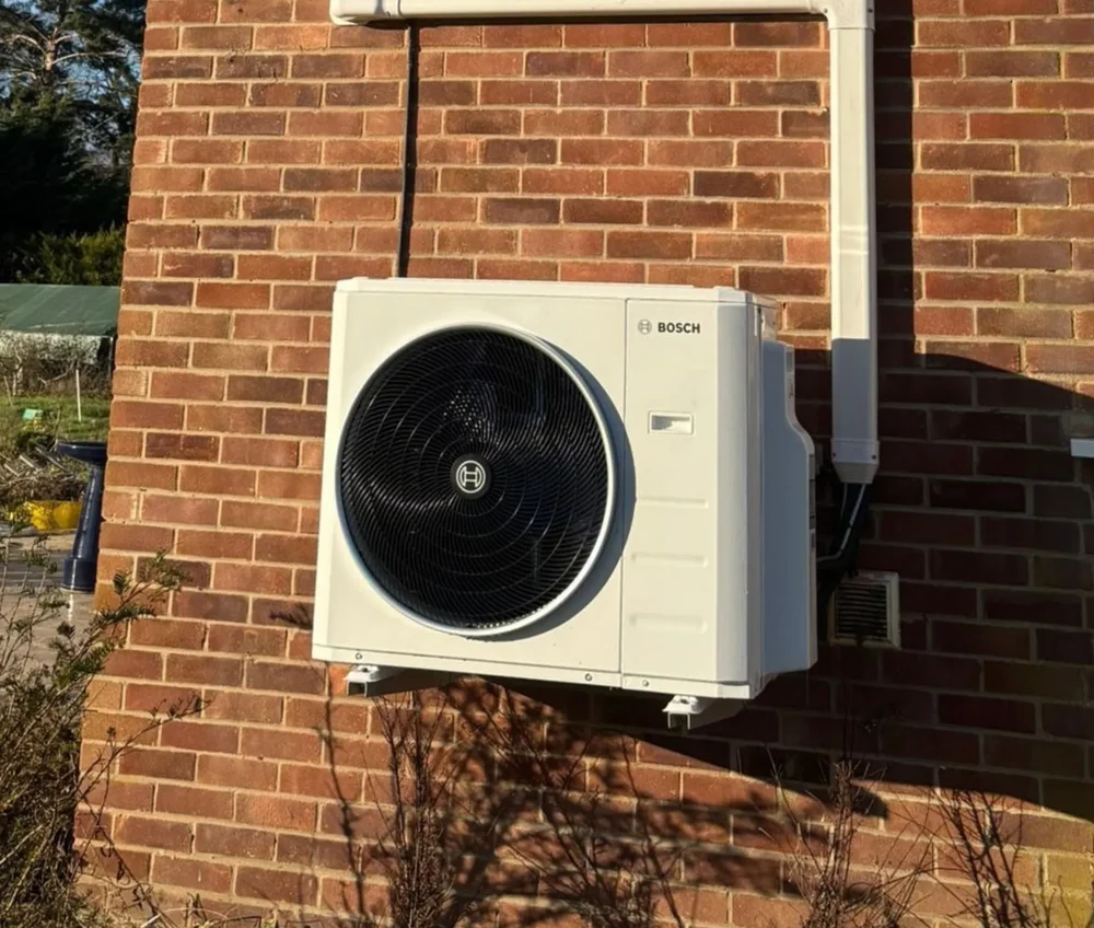 A Bosch outdoor unit fitted to a brick wall