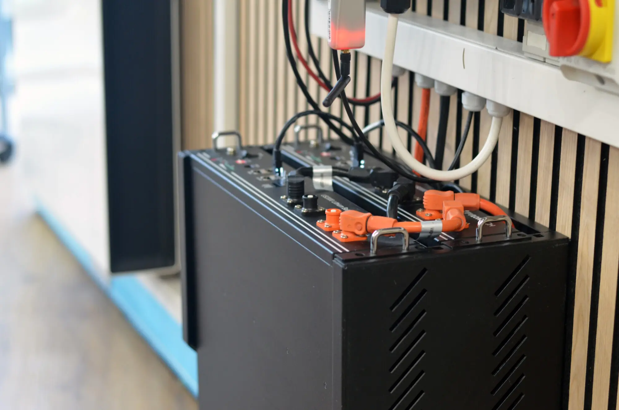 A home battery with its cabling on a wall