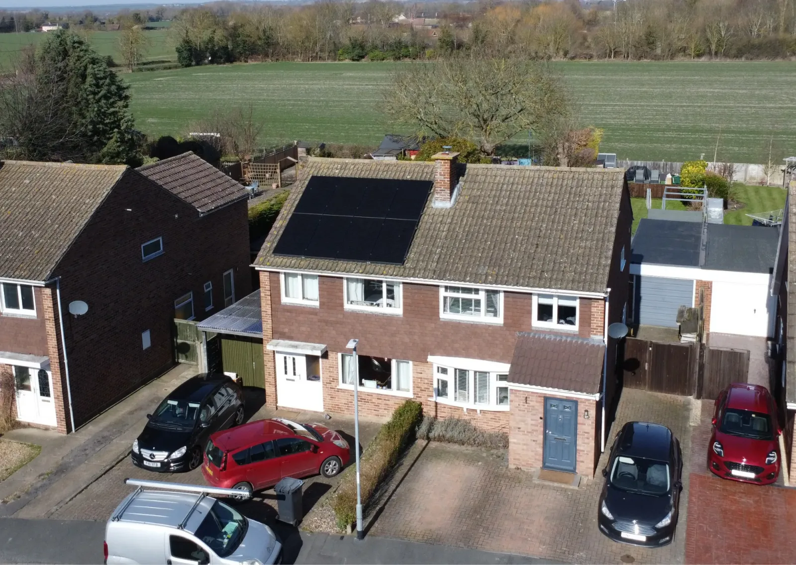 Aerial view of David's semi-detached brick home with eight black solar panels