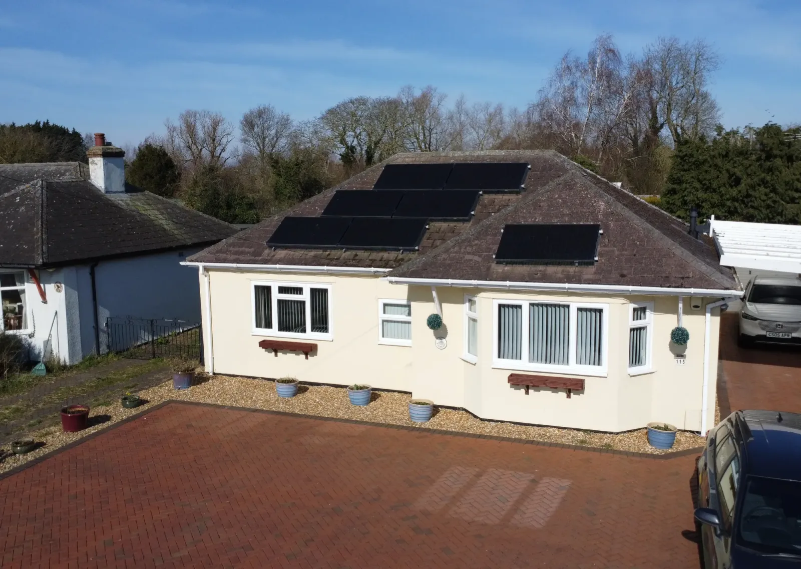 Colin's cream bungalow with black solar panels on the roof