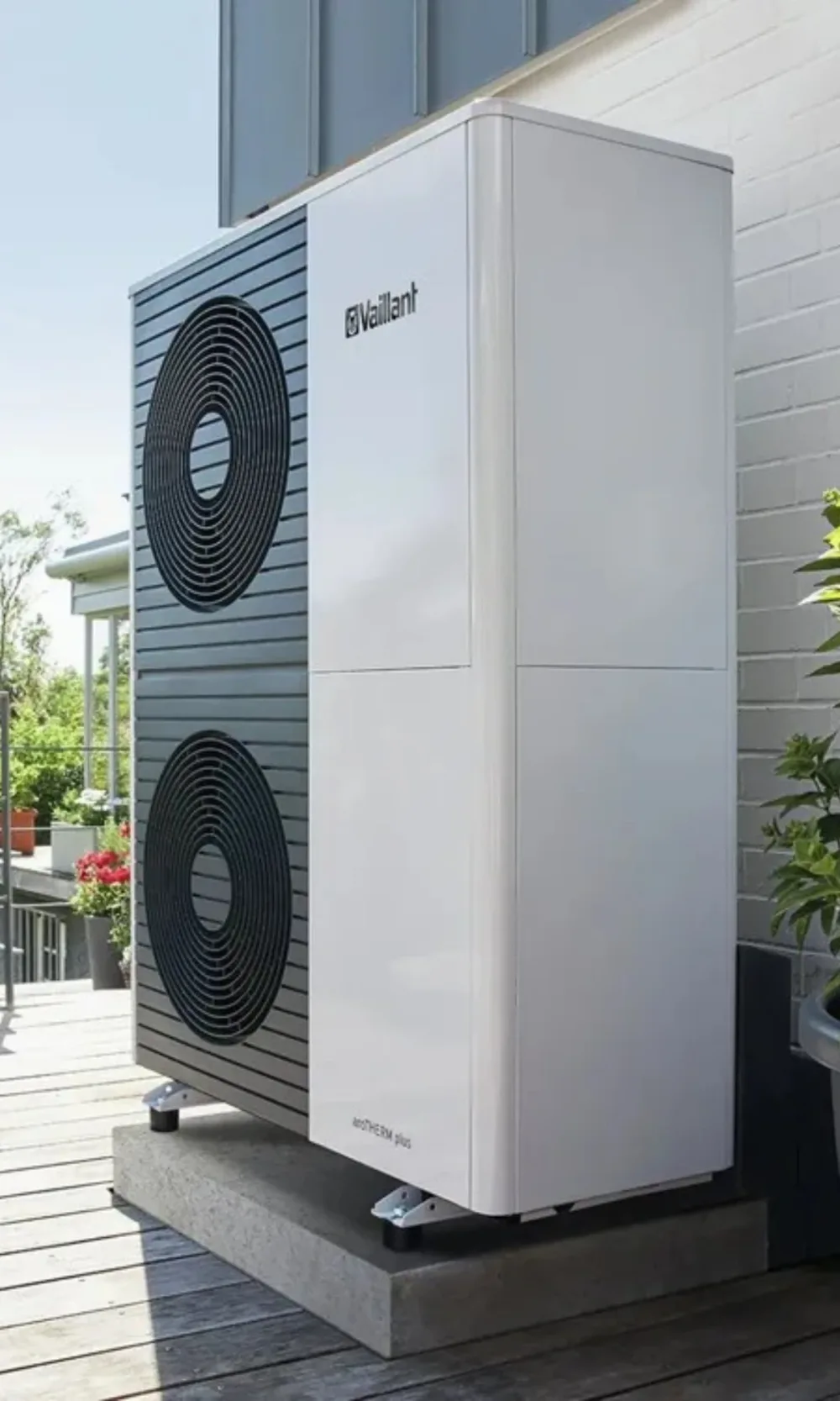 A large two-fan Vaillant aroTHERM Plus heat pump on a decked terrace