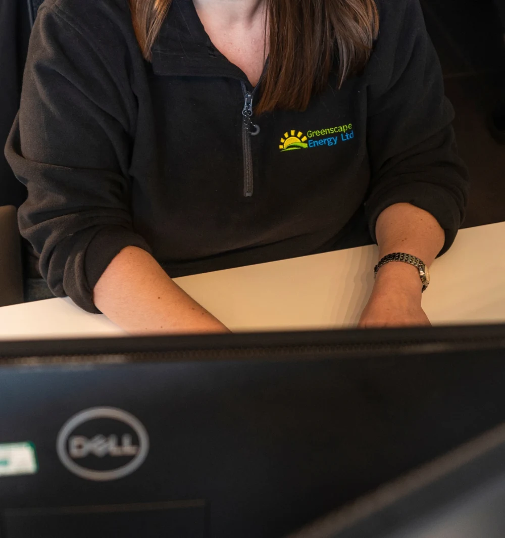 A member of the customer support team working at a computer