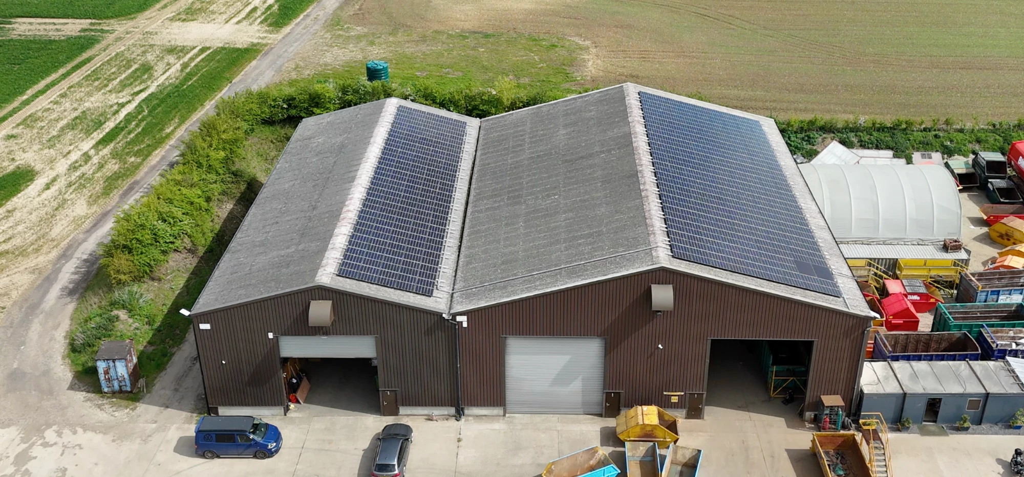 An installer in a hard hat fixing a solar panel