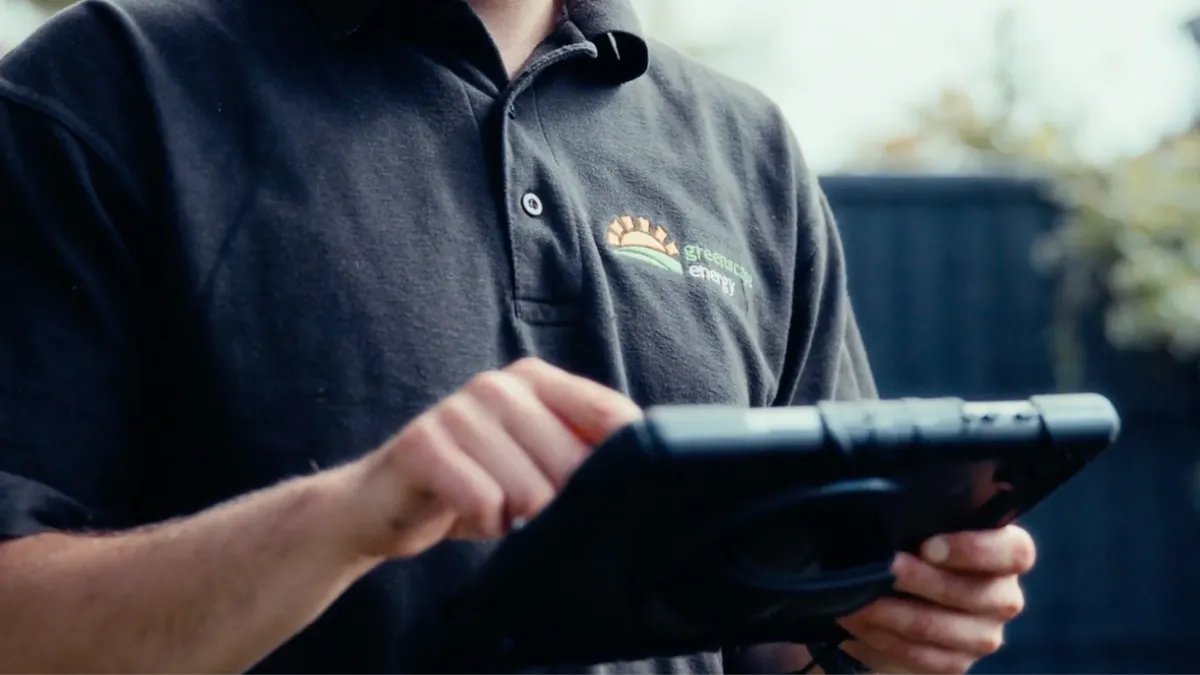A Greenscape engineer checking a tablet