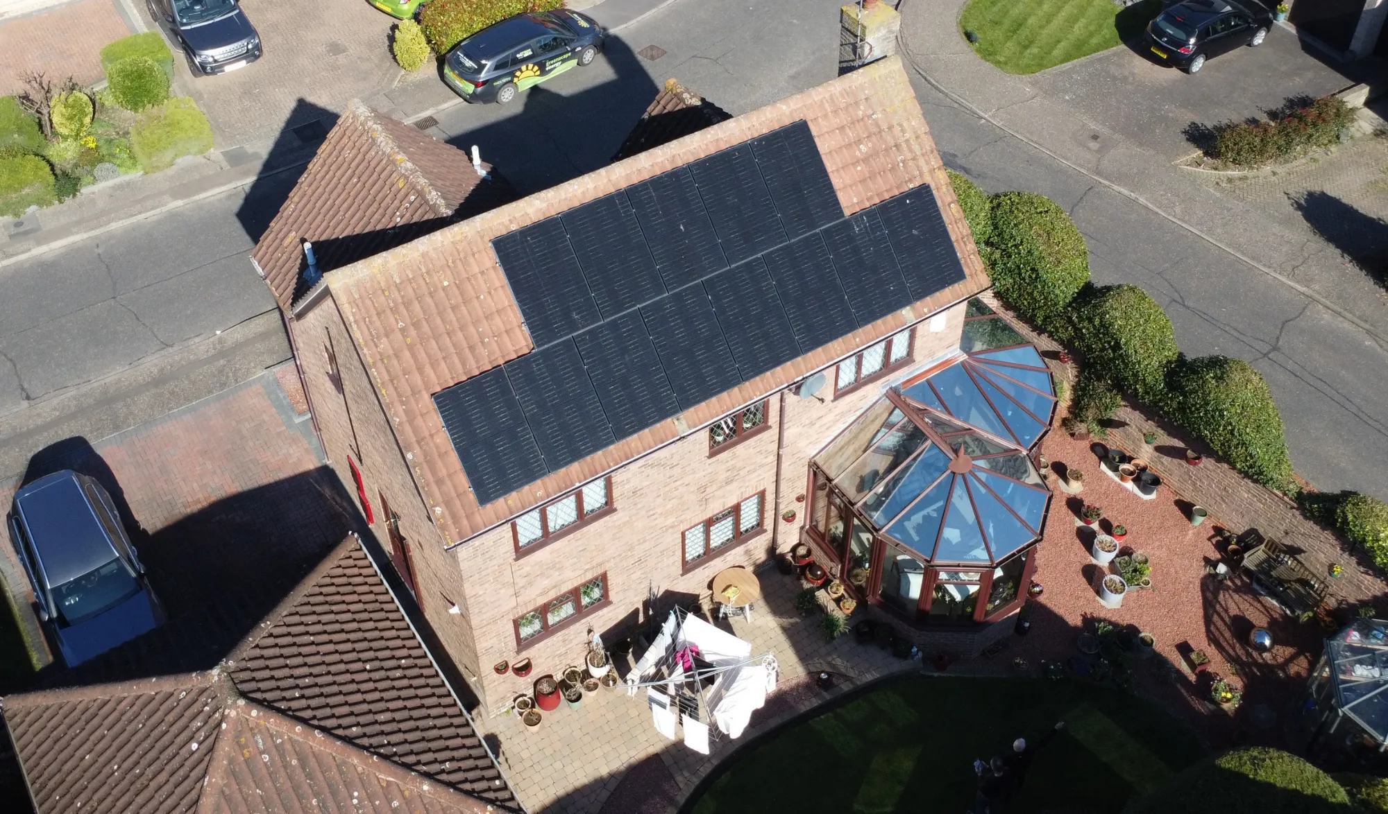 Two installers positioning a solar panel