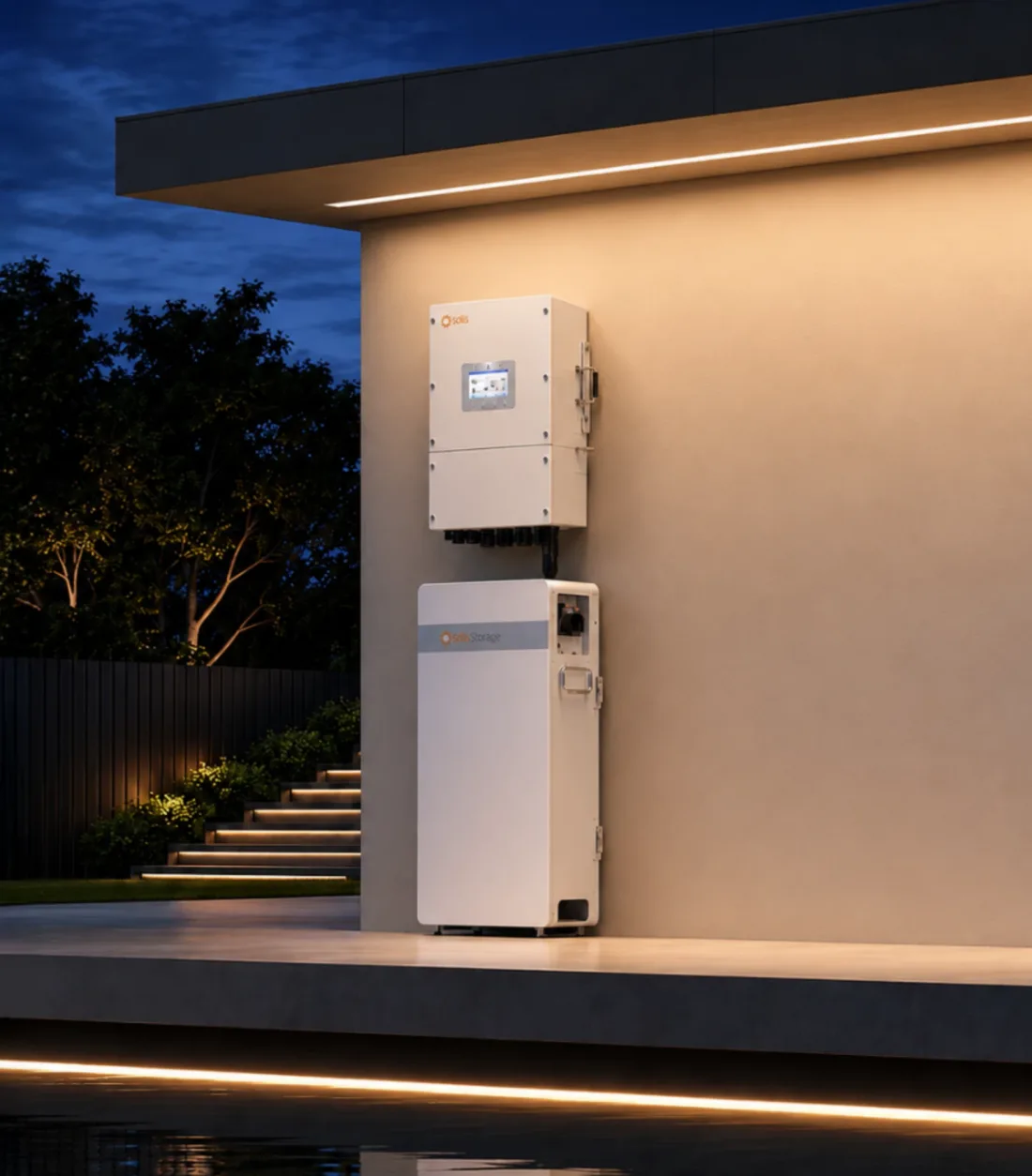 A Solis inverter above a Solis Storage battery on a wall lit warmly at dusk