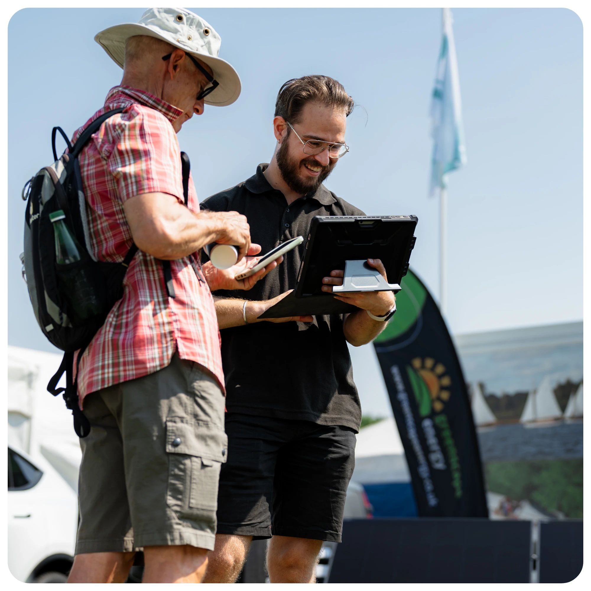 A Greenscape Energy adviser shaking hands with visitors at a show